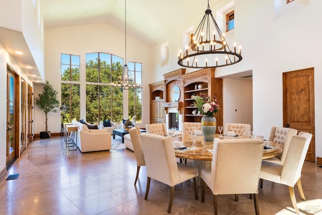 dining area with a notable chandelier and high vaulted ceiling