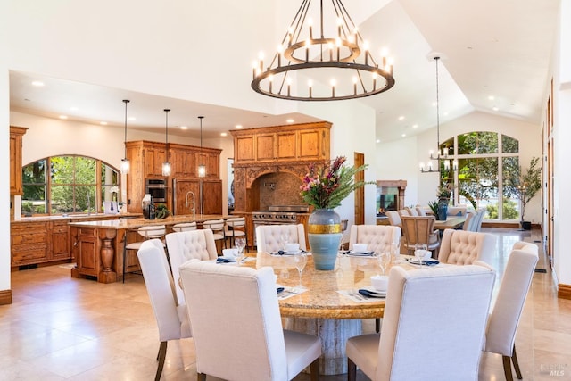 dining room featuring a notable chandelier, high vaulted ceiling, and sink