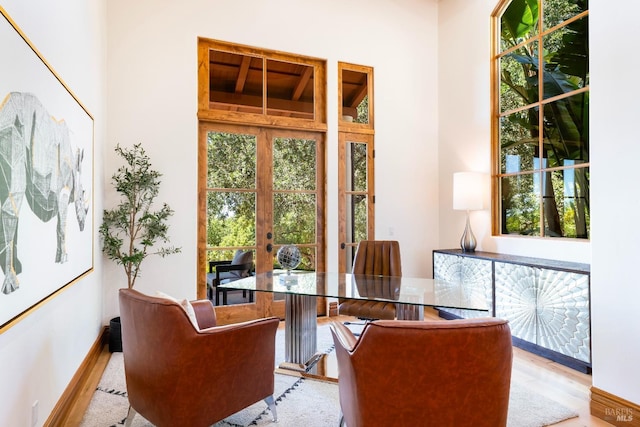 sitting room featuring light wood-type flooring and french doors