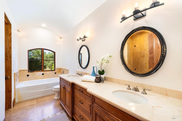 bathroom with vanity, a tub to relax in, tile patterned floors, and toilet