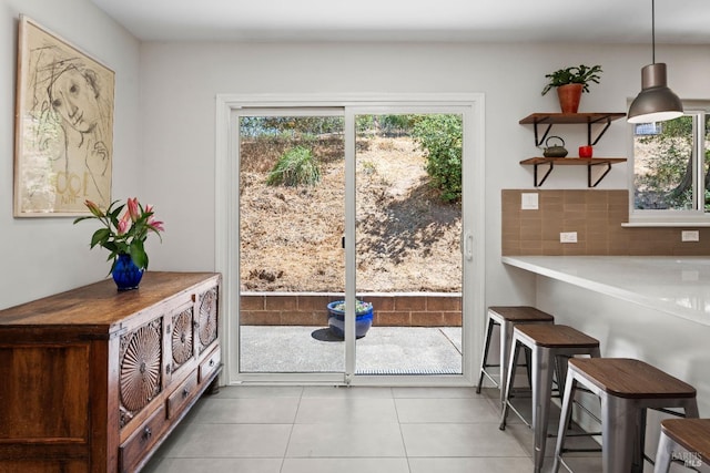 doorway to outside featuring light tile patterned floors