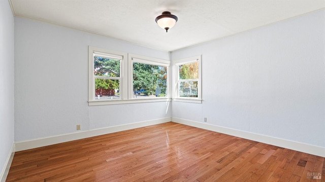 unfurnished room with light wood-type flooring