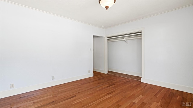 unfurnished bedroom featuring a closet and wood-type flooring