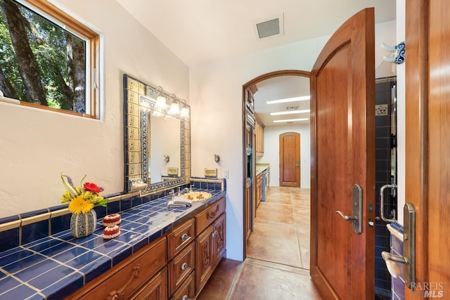 bathroom featuring tile patterned flooring and vanity