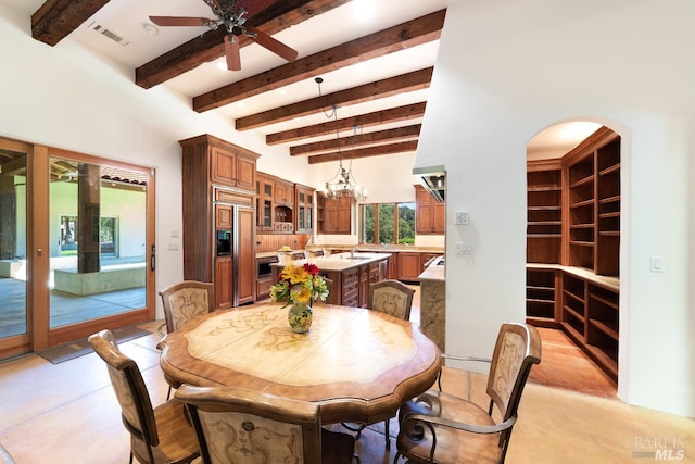 dining space with ceiling fan, beam ceiling, and sink