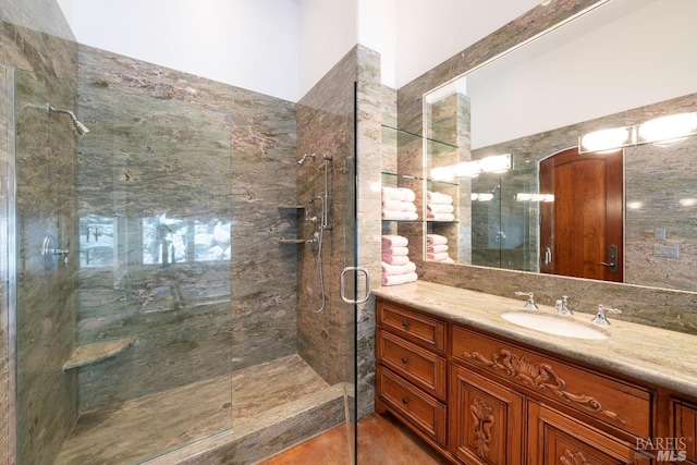 bathroom featuring a shower with door, tile patterned floors, and vanity