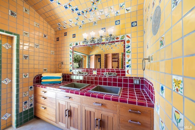 bathroom with sink, tasteful backsplash, and lofted ceiling