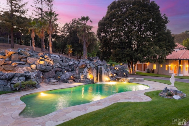 pool at dusk with pool water feature