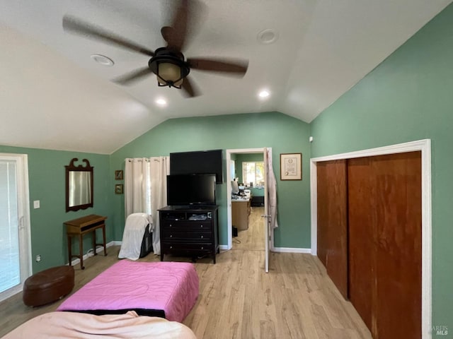 bedroom with lofted ceiling, light wood-style floors, baseboards, and a ceiling fan