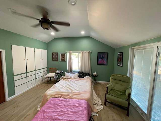 bedroom with lofted ceiling, ceiling fan, light wood-style flooring, and baseboards