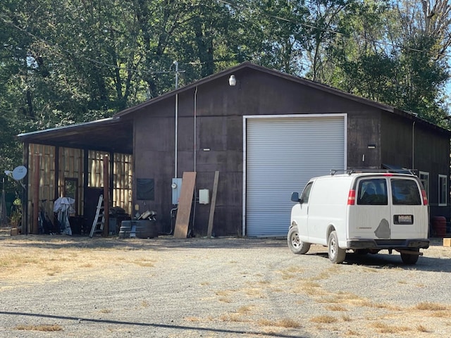 garage featuring driveway and a detached garage