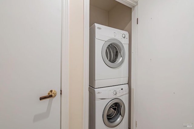 laundry room with stacked washing maching and dryer and laundry area