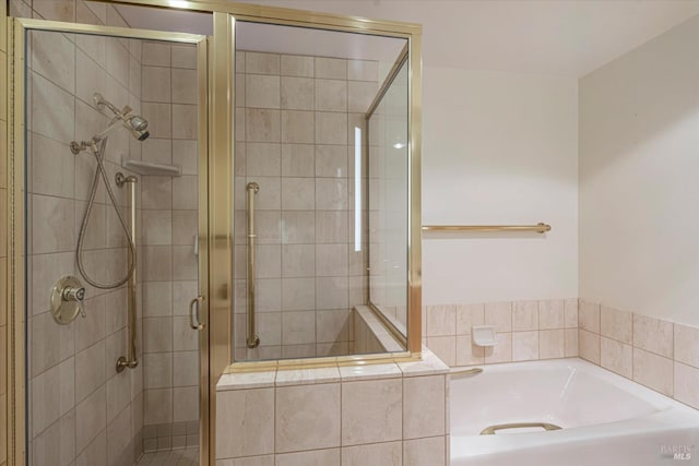 bathroom with separate shower and tub