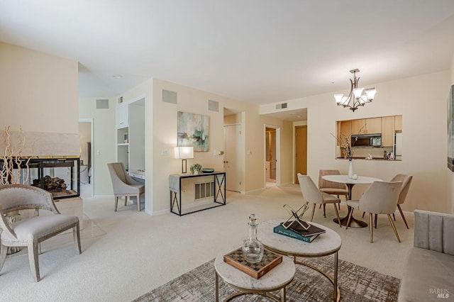 living room with light colored carpet, a notable chandelier, and visible vents