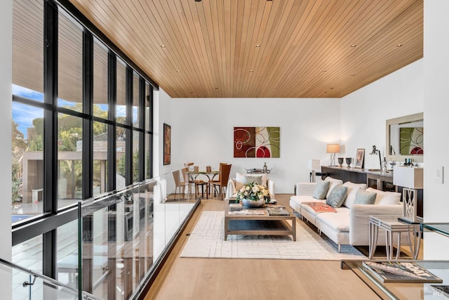 living room with light hardwood / wood-style flooring, wooden ceiling, and floor to ceiling windows