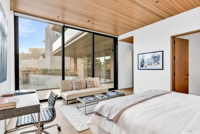 bedroom featuring expansive windows, wood ceiling, and access to outside