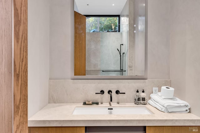 bathroom featuring vanity and tasteful backsplash