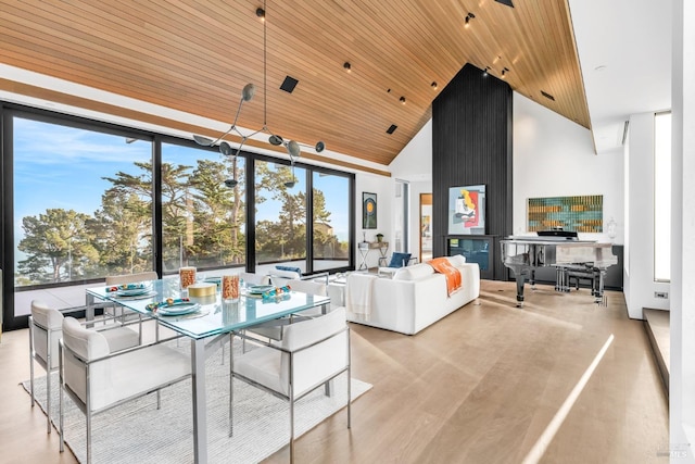 interior space with floor to ceiling windows, light hardwood / wood-style floors, high vaulted ceiling, and wooden ceiling