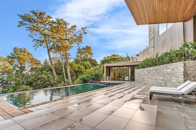 view of swimming pool with a patio area