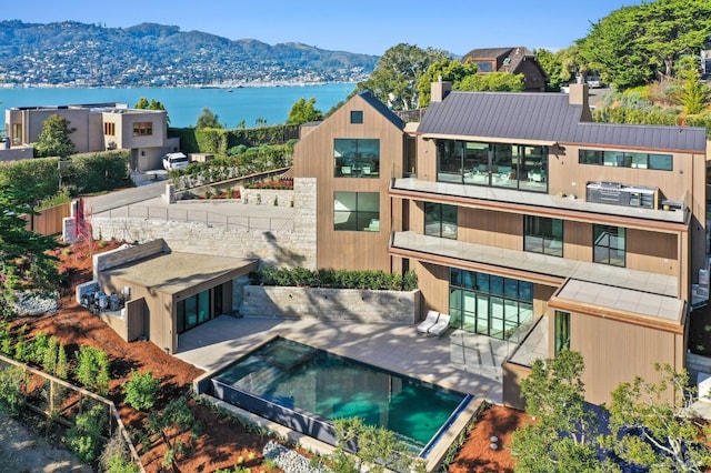 exterior space featuring a water and mountain view