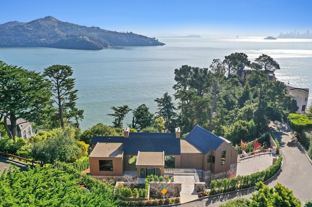 birds eye view of property with a water and mountain view