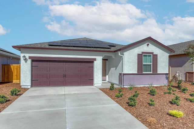 view of front of property with a garage and solar panels