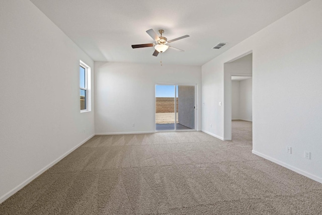 empty room featuring light colored carpet and ceiling fan