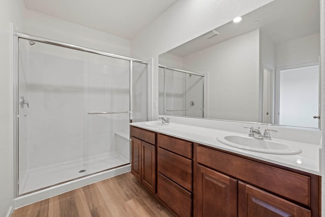 bathroom featuring vanity, an enclosed shower, and hardwood / wood-style floors