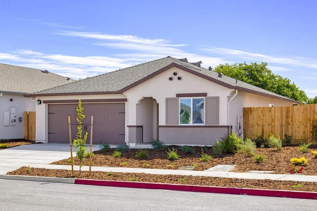 view of front of house with roof with shingles, stucco siding, concrete driveway, an attached garage, and fence