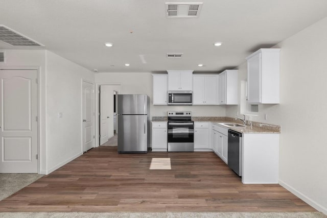 kitchen featuring white cabinets, visible vents, and appliances with stainless steel finishes