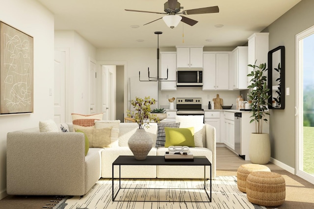living area with light wood-style floors, baseboards, and a ceiling fan