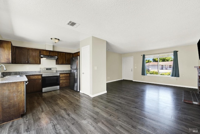 kitchen featuring appliances with stainless steel finishes, dark hardwood / wood-style floors, sink, dark brown cabinets, and a textured ceiling