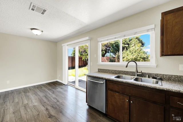 kitchen featuring sink, dishwasher, dark brown cabinets, dark hardwood / wood-style floors, and a textured ceiling