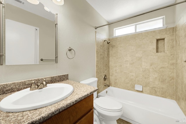 full bathroom featuring vanity, toilet, and tiled shower / bath