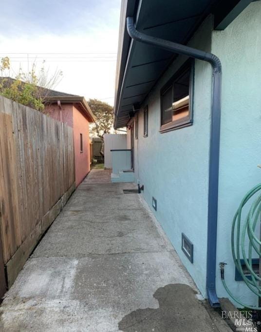 view of property exterior with a patio area