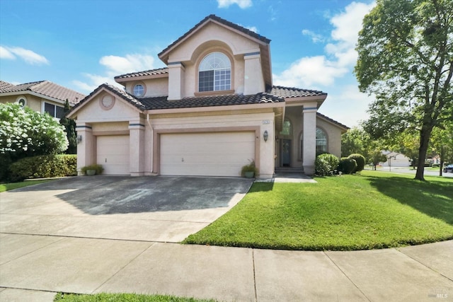 mediterranean / spanish house with a front yard and a garage