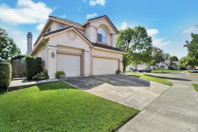 view of front property featuring a front lawn and a garage