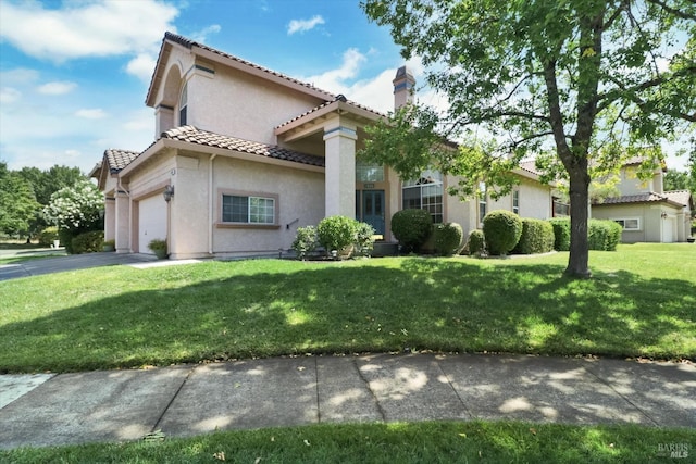 mediterranean / spanish-style house featuring a front yard