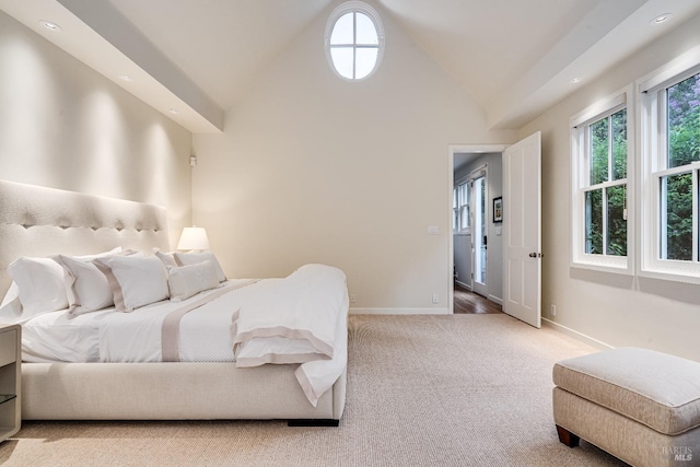 carpeted bedroom featuring high vaulted ceiling