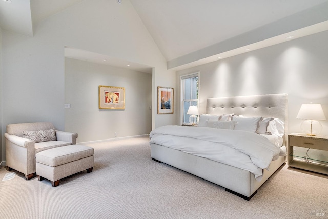 carpeted bedroom featuring high vaulted ceiling