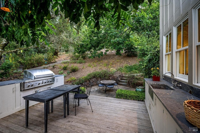 deck featuring sink and a grill