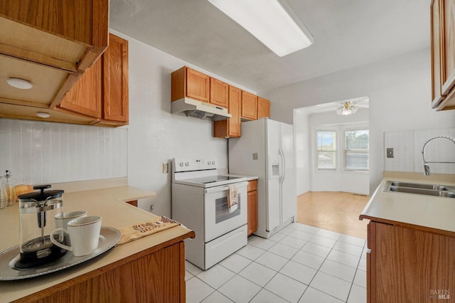 kitchen featuring ceiling fan, sink, tasteful backsplash, white appliances, and light tile patterned flooring