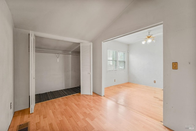 unfurnished bedroom with lofted ceiling and wood-type flooring