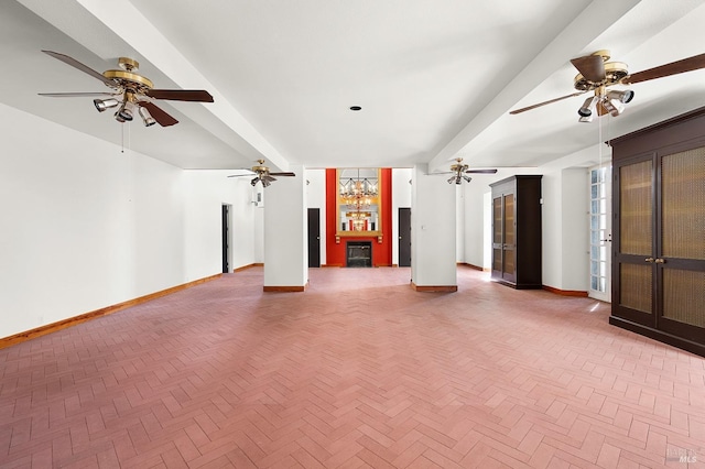 unfurnished living room with beamed ceiling, baseboards, and ceiling fan