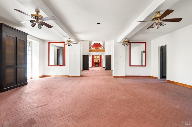 empty room featuring baseboards and ceiling fan