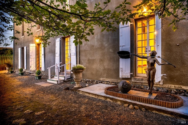 exterior space with entry steps and french doors