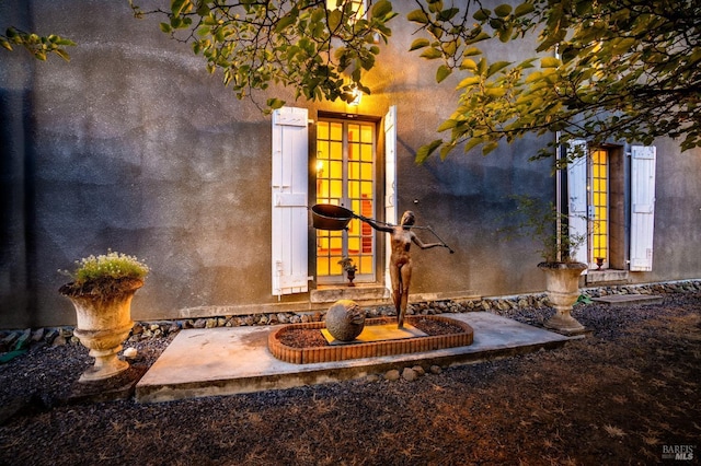 exterior details featuring french doors and stucco siding