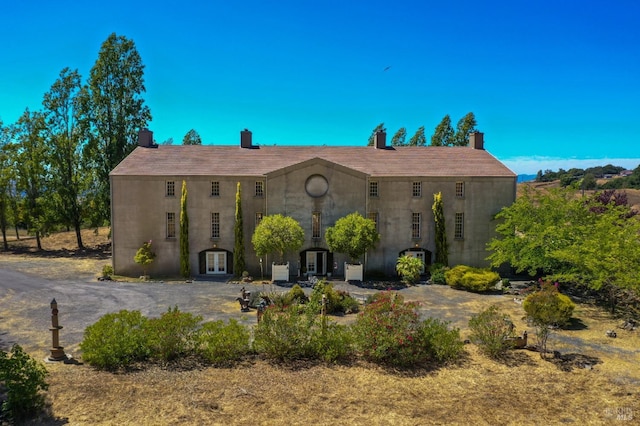 view of front of home with french doors and a chimney