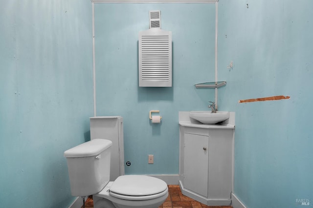 bathroom with visible vents, baseboards, toilet, and vanity