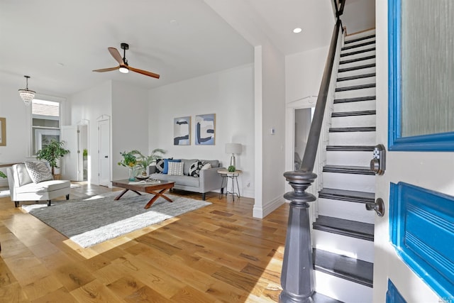 unfurnished living room featuring wood-type flooring and ceiling fan